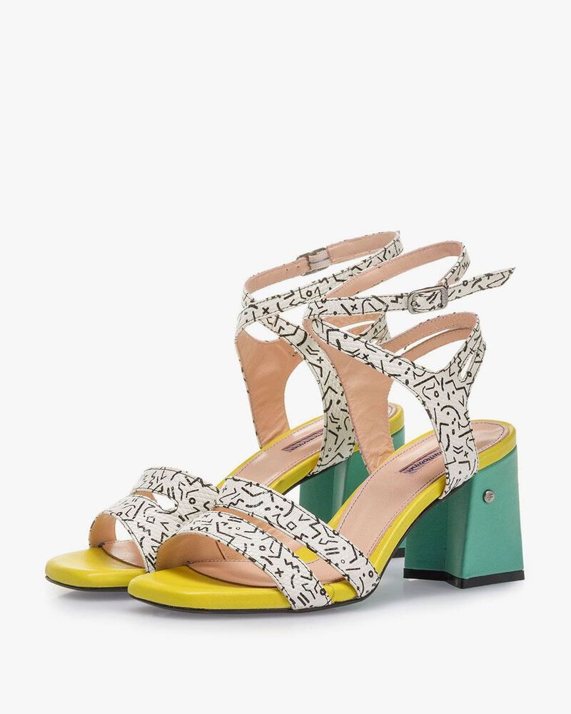 White high-heeled sandals with black print