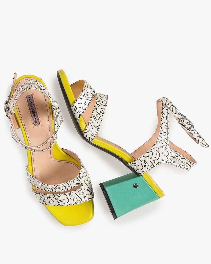 White high-heeled sandals with black print